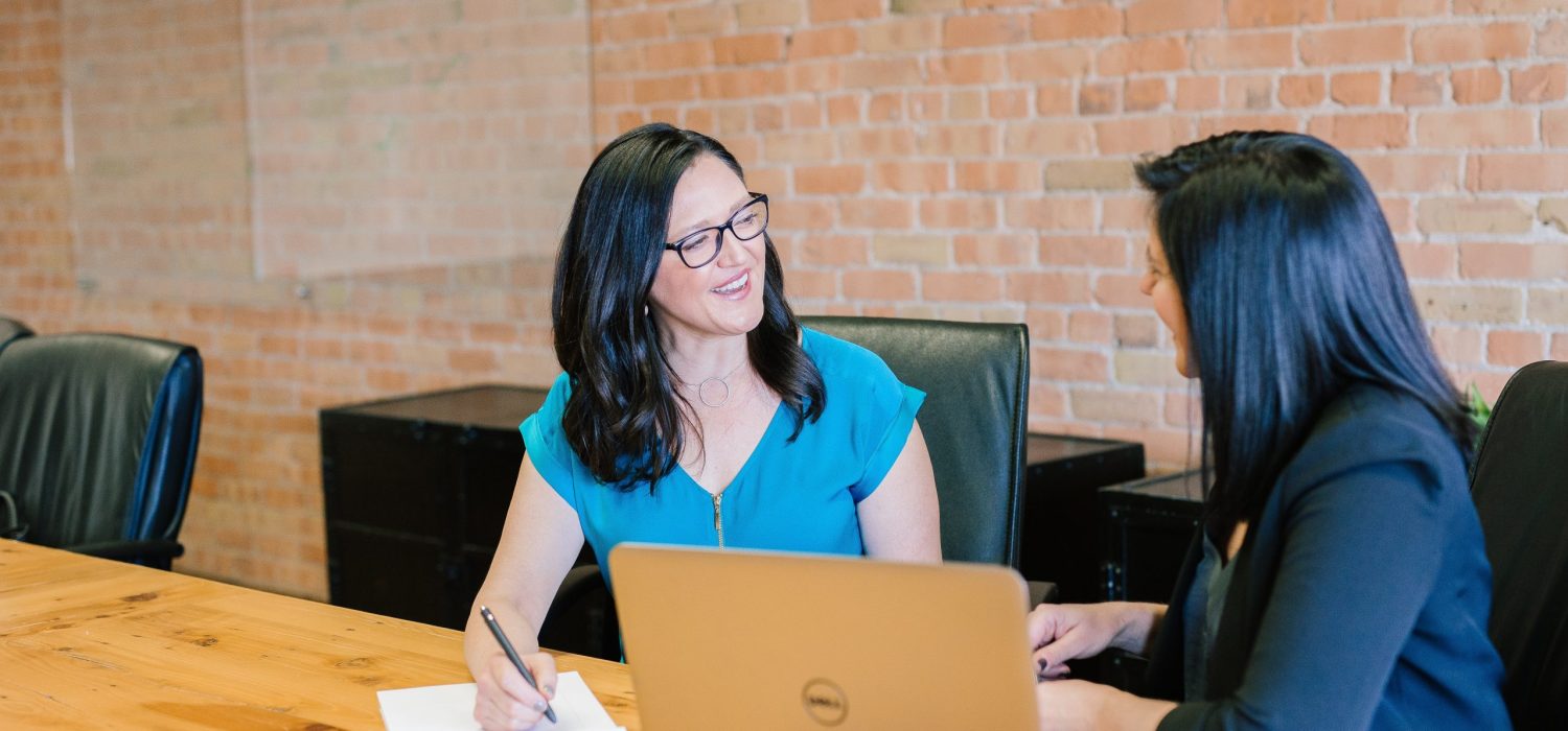 Discuss the 2022 retirement contribution limits with your financial advisor Two businesswomen in a meeting having a friendly discussion